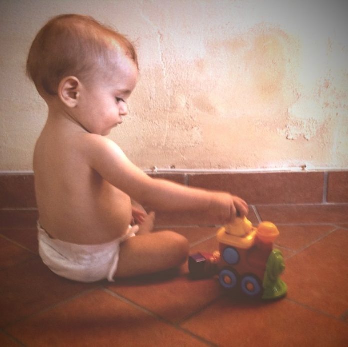 baby plays with toy