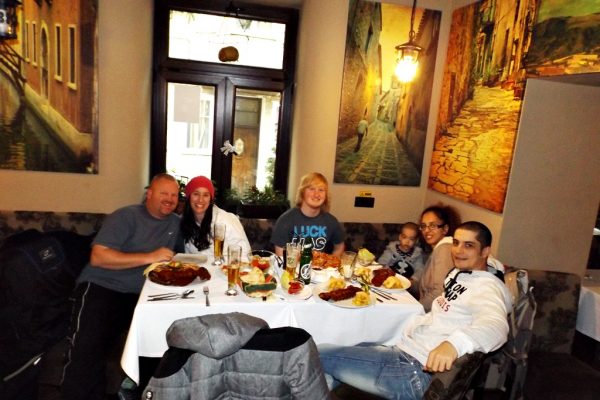 The American and the Romanian family enjoying dinner in Brasov