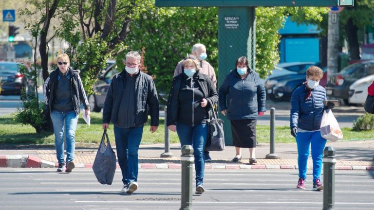 people wearing surgical masks in romania
