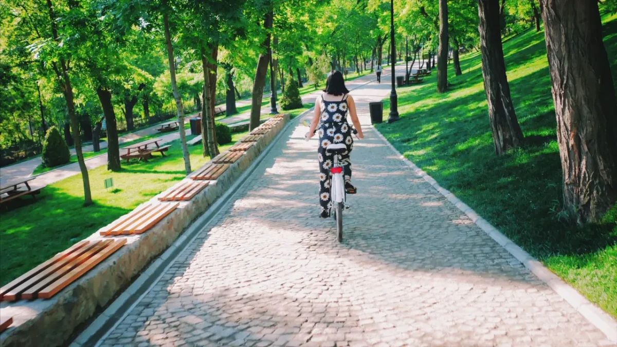 woman riding her bike in a park in Romania