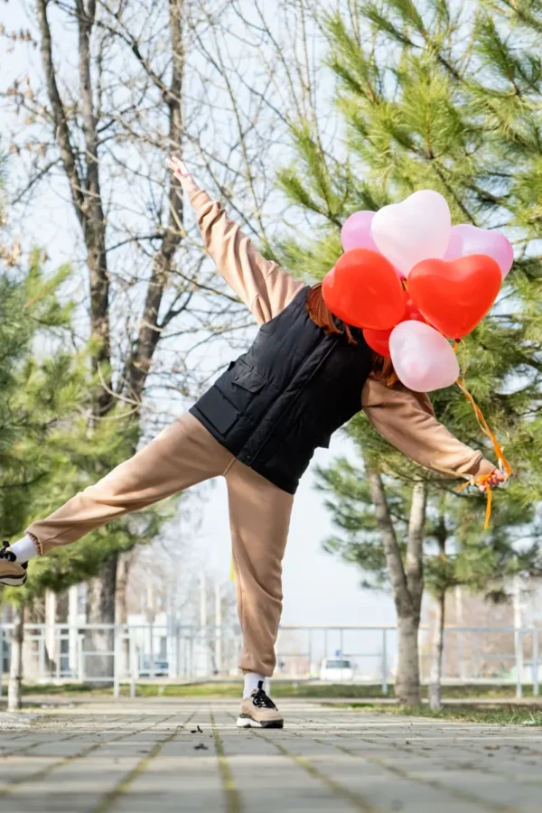 woman holding heart shaped balloons