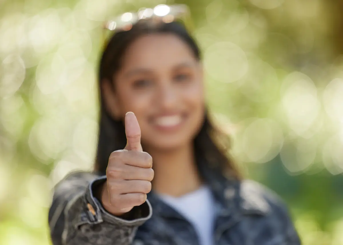 young woman giving a thumbs up