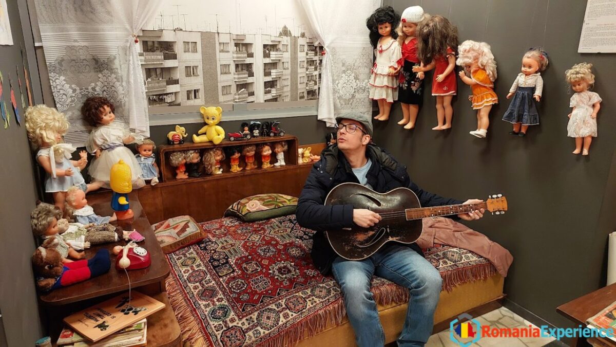 blogs author playing the guitar in a communist era apartment