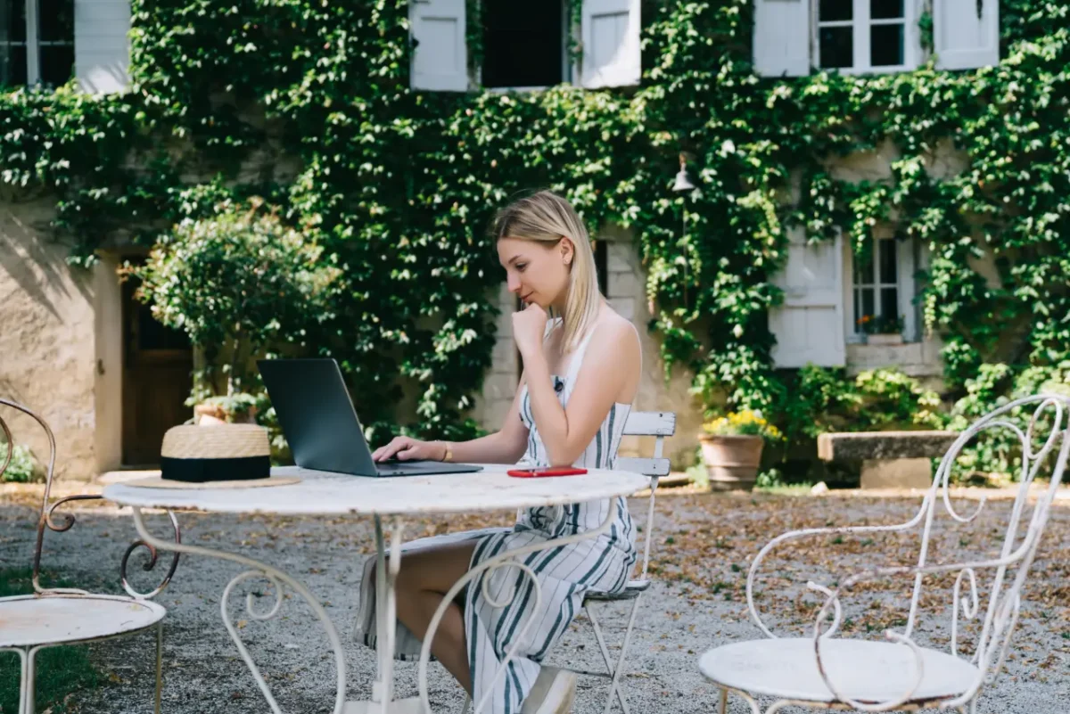 young digital nomad working from a courtyard in Romania