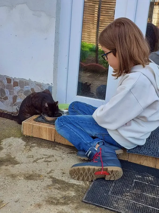 My son and a visiting black cat