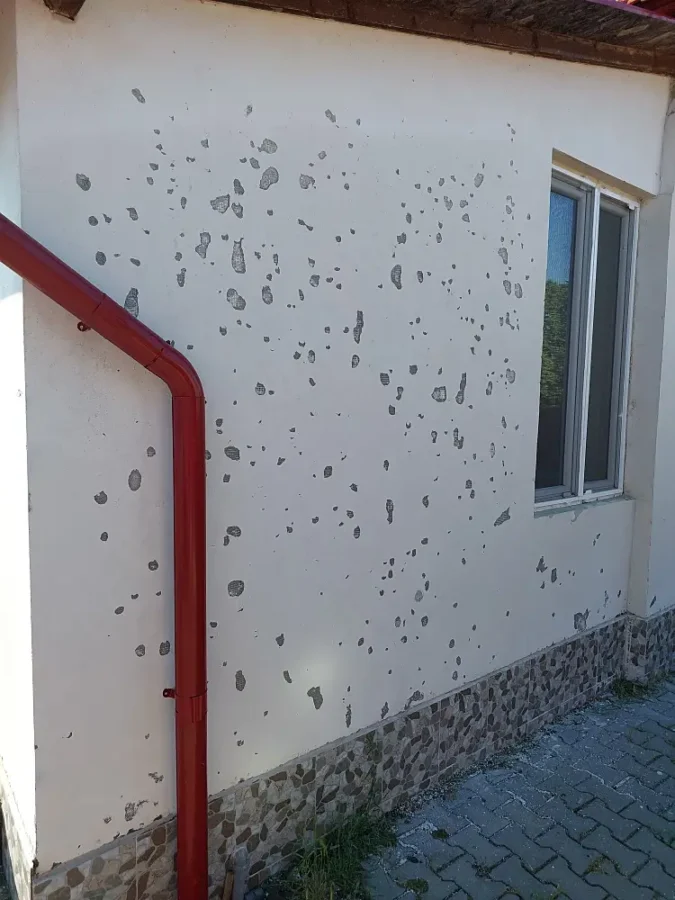 house wall affected by hail